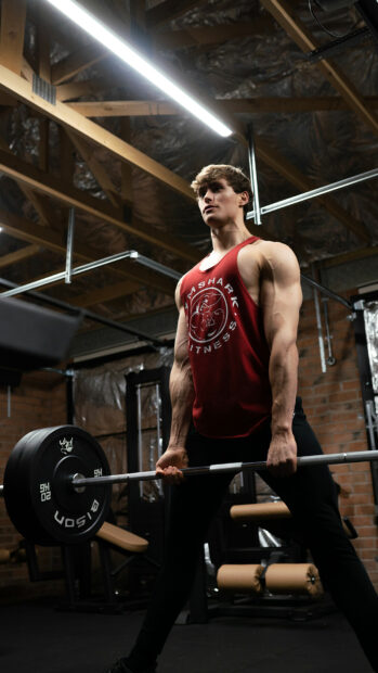 A powerlifter is focused while lifting weights in the gym, HD Phone Wallpaper