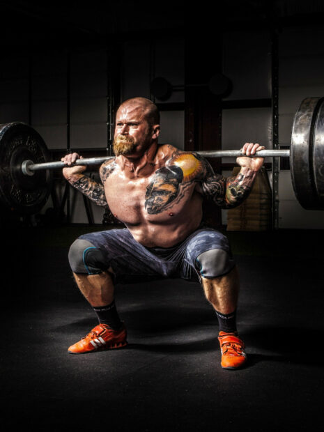 A tattooed man lifts a heavy barbell in the gym, HD Mobile Wallpaper