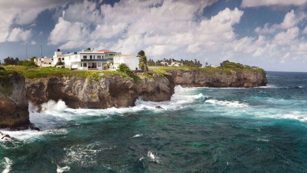 Waves crashing below cliffs near houses in the Dominican Republic, HD Desktop Wallpaper