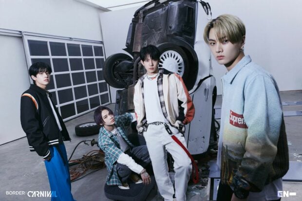 Enhypen members pose confidently in an industrial setting with a wrecked car, HD Desktop Wallpaper