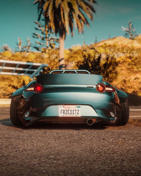 A Mazda car with round taillights is parked on a road with palm trees in the background, 2K Mobile Wallpaper