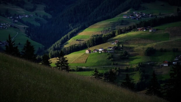 The green hills wallpapers show sunlit rolling hills with houses and trees, 4K Desktop Wallpaper