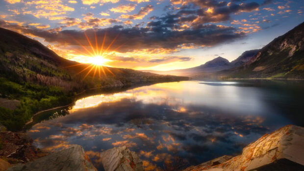 The sun sets over Montana mountains reflecting in the calm lake, 4K Desktop Wallpaper