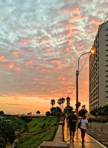 People walking along the street during sunset in Lima Peru, 2K Mobile Wallpaper