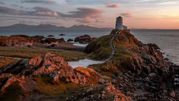 A scenic path leads to a lighthouse overlooking the rocky coastline in Wales wallpapers, 4K Desktop Wallpaper
