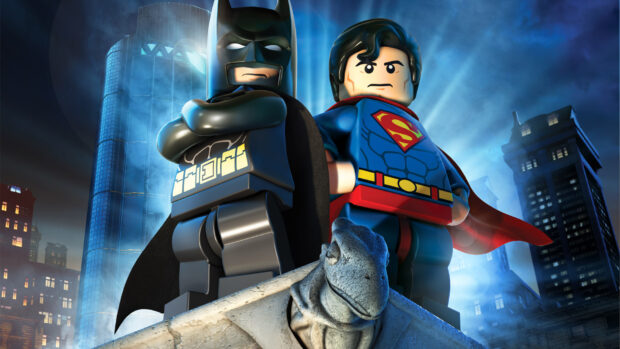 Batman and Superman figure pose on a statue at night, HD Desktop Wallpaper