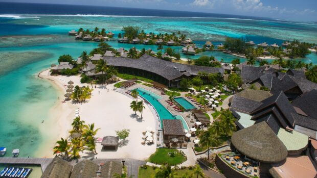 Aerial view of Tahiti resort with lush greenery and turquoise water in a tropical paradise