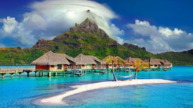 Tropical island scenery with bungalows and palm trees in Tahiti