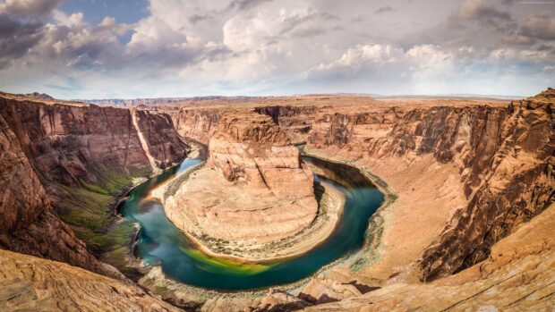 The Colorado River flowing through a winding canyon surrounded by rocky desert cliffs