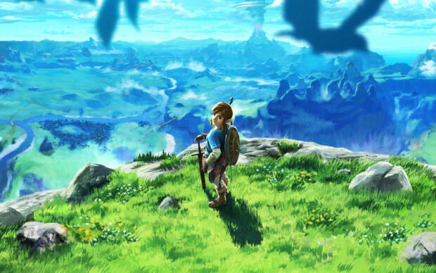 Link stands on a cliff overlooking a vast landscape from The Legend of Zelda, 2K Desktop Wallpaper