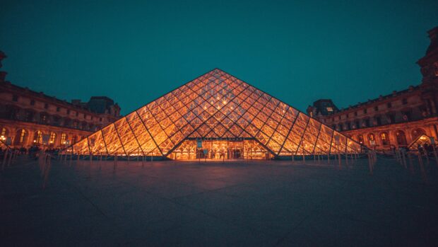 The Louvre glass pyramid illuminated at night in Paris France