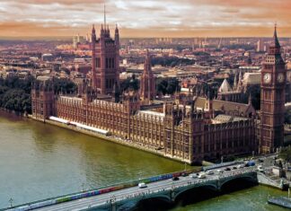 Houses of Parliament and Big Ben in London with Westminster Bridge over the River Thames, historic UK landmark and government building architectural view.