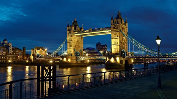 The River Thames is beautifully illuminated along the iconic Tower Bridge under the evening sky, 4K Desktop Wallpaper