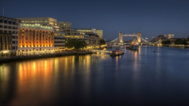 The River Thames shows a calm river scene with illuminated buildings and Tower Bridge in the background, HD Desktop Wallpaper