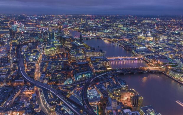 The River Thames flows through a vibrant cityscape with illuminated bridges and buildings at dusk, HD Desktop Wallpaper
