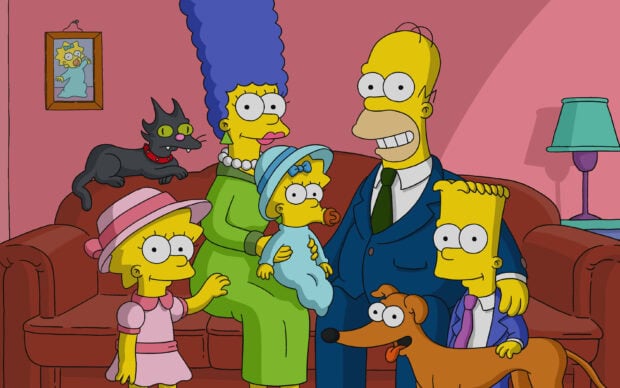 The Simpsons characters family sitting on the sofa with pets in a cozy living room