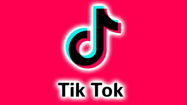 Tik Tok logo design in black with blue and red outline on bright pink background
