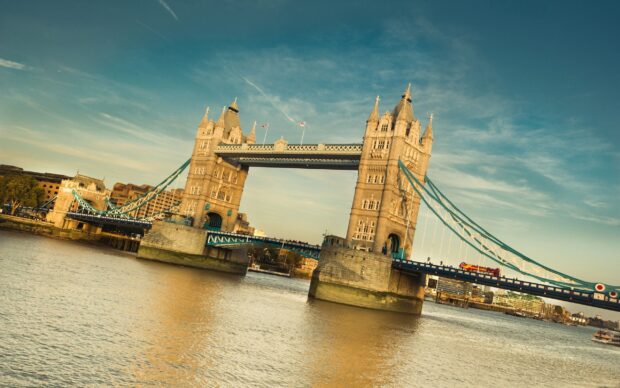 The River Thames features the iconic Tower Bridge and calm water below during sunset, 2K Desktop Wallpaper