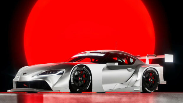 Futuristic silver race car with aerodynamic design and Bridgestone tires, set against a red glowing circular background.