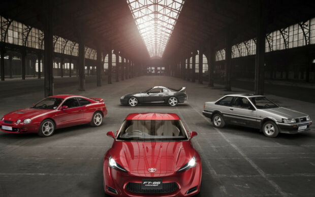 Sports car collection in an industrial warehouse.