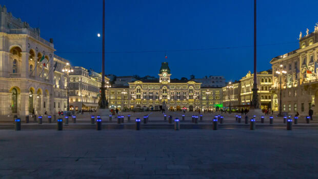 The illuminated buildings in Trieste create a stunning cityscape under the evening sky, HD Desktop Wallpaper