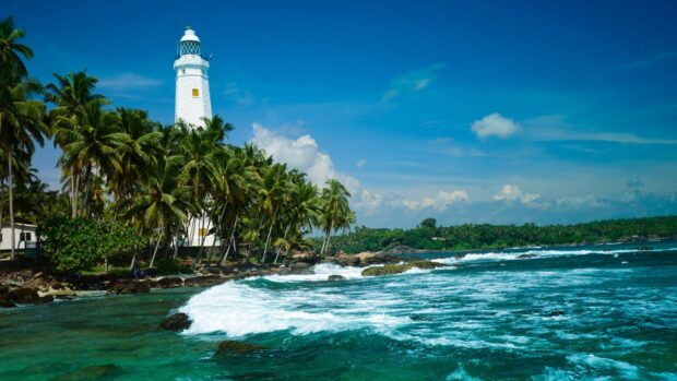The Sri Lanka wallpapers show a white lighthouse surrounded by palm trees near the blue ocean waves