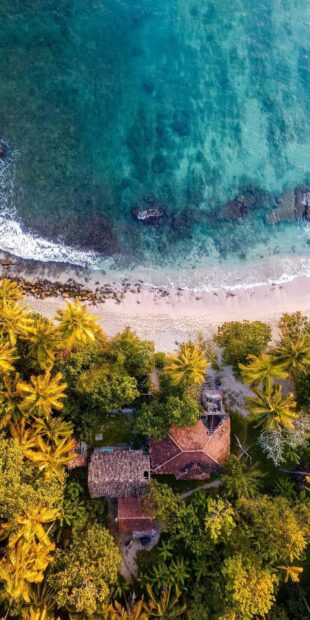 Aerial view of a tropical coastline with houses and clear blue water in Sri Lanka, HD Mobile Wallpaper
