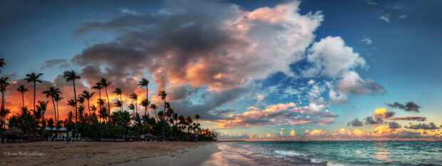 The Dominican Republic features a tropical beach with palm trees and colorful sunset clouds, 2K Desktop Wallpaper