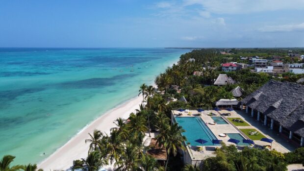 Aerial view of Zanzibar coastline with turquoise sea and white sand beaches, 2K Desktop Wallpaper