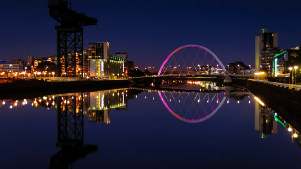 The United Kingdom Wallpapers captures a city river with illuminated buildings and a glowing bridge at night, HD Desktop Wallpaper
