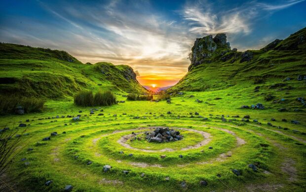 A sunset over a stone circle in the green hills of the United Kingdom showcasing natural beauty, 2K Desktop Wallpaper
