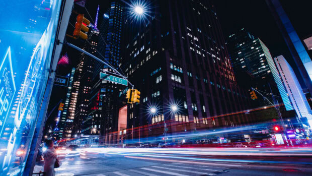 Busy street scene of United States cityscape at night with light trails