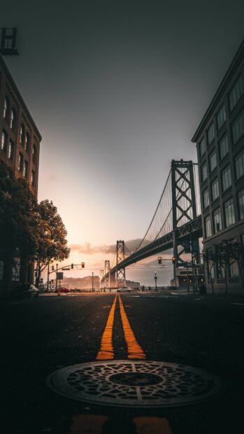Historic bay bridge in United States viewed from city street at sunset