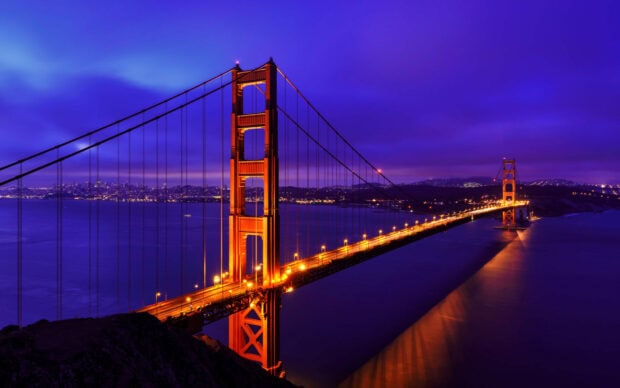The Golden Gate Bridge illuminated over the San Francisco Bay at night in United States