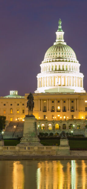Evening view of the United States Capitol with an equestrian statue in front