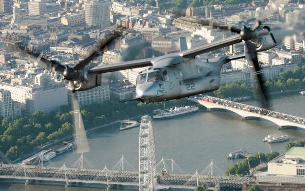 V 22 Osprey aircraft flying over London cityscape above the river and bridges