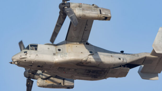 A military aircraft V 22 Osprey flying in clear blue sky