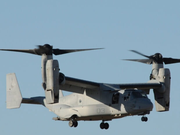 A V 22 Osprey aircraft flying in clear blue sky