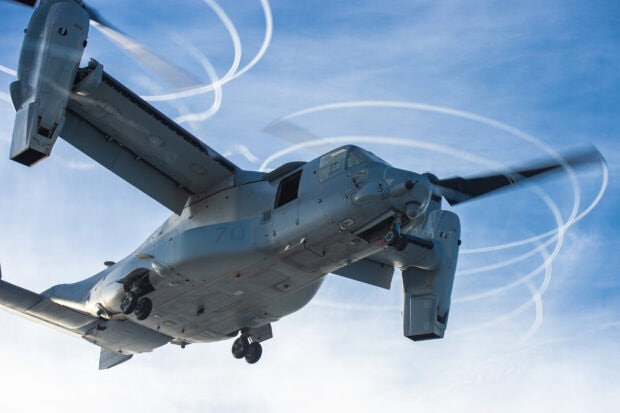Close up of V 22 Osprey aircraft flying against a clear blue sky