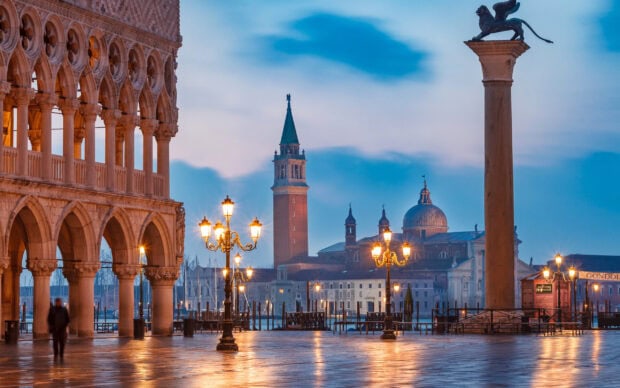 The St Marks Square displays historic architecture and glowing street lamps at dusk, 2K Desktop Wallpaper