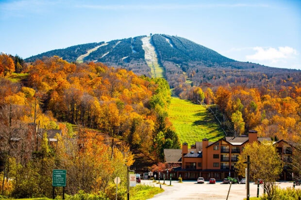 The Vermont scene shows colorful autumn trees and a mountain lodge, HD Desktop Wallpaper