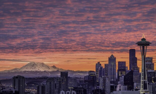 The vibrant Seattle skyline features Mount Rainier during a colorful sunset with scattered clouds, HD Desktop Wallpaper