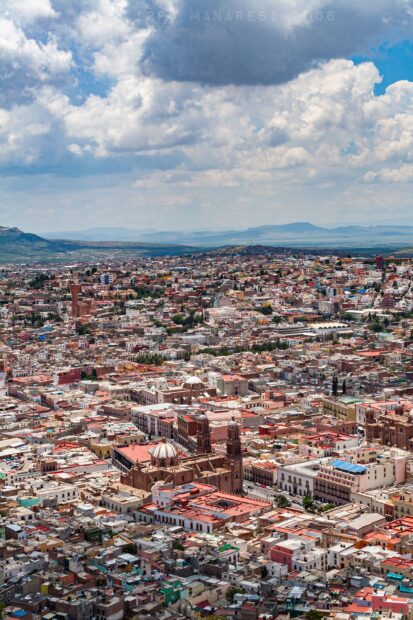 A vibrant cityscape of Bogota shows detailed buildings and cloudy sky, 2K Phone Wallpaper