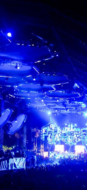A vibrant nightclub with bright blue lights and a lively crowd enjoying the music, HD Mobile Wallpaper