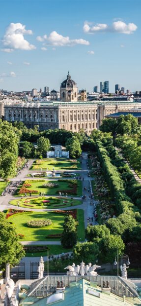Beautiful Vienna Austria castle and garden with lush greenery and clear blue sky