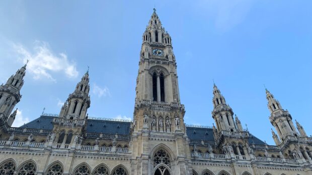 Gothic architecture of Vienna Austria with clock tower under blue sky