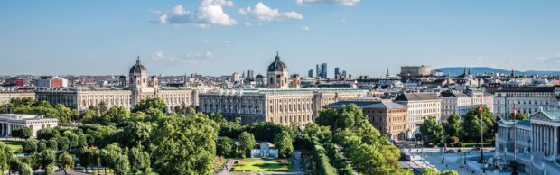 Historic Vienna Austria cityscape with green parks under a blue sky