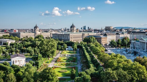 Beautiful Vienna Austria cityscape with historic buildings and green parklands under a clear blue sky