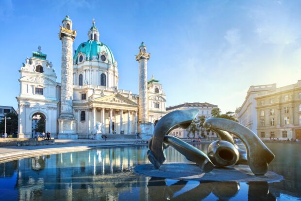 The grand historical architecture of Vienna Austria with a reflective water fountain in front