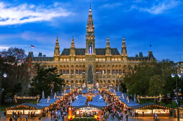 The Vienna cityscape with Vienna Christmas market and historic townhall at dusk